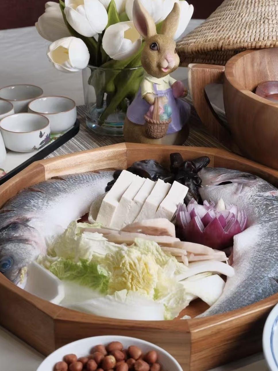 八角木盤上的整條鮮魚，中間擺著豆腐、木耳、白菜與洋蔥花